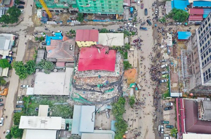 This aerial photo taken on June 22, 2019 shows a collapsed building at a construction site in Sihanoukville. – At least three construction workers died when a seven-storey building collapsed.