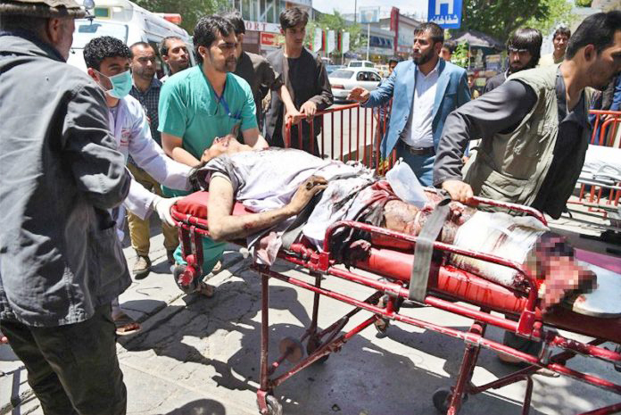 An injured Afghan man is brought on a stretcher to an Italian aid organisation’s hospital after a car bomb attack in Kabul on July 1, 2019. – Dozens of people were wounded with fatalities feared in a Taliban-claimed attack which saw a powerful car bomb rock Kabul early July 1.